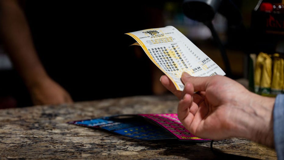 A customer looks at their lottery tickets before purchasing at a CITGO gas station on Jan. 10, 2023, in Austin, Texas. (Photo by Brandon Bell/Getty Images)