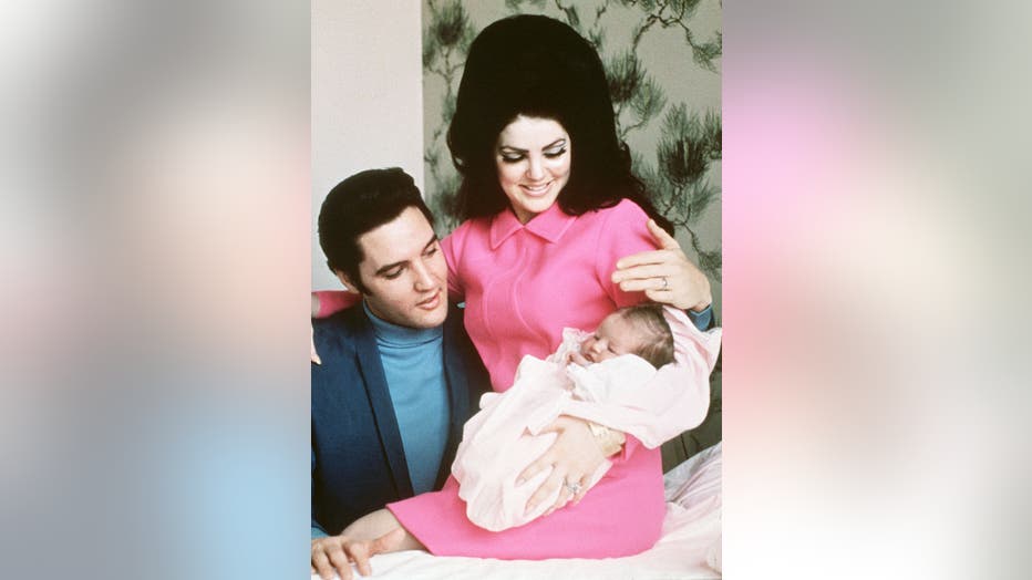 Elvis Presley and his wife, Priscilla, prepare to leave the hospital with their new daughter, Lisa Marie, in Memphis, Tennessee, on Feb. 5, 1968. (Credit: Getty Images)