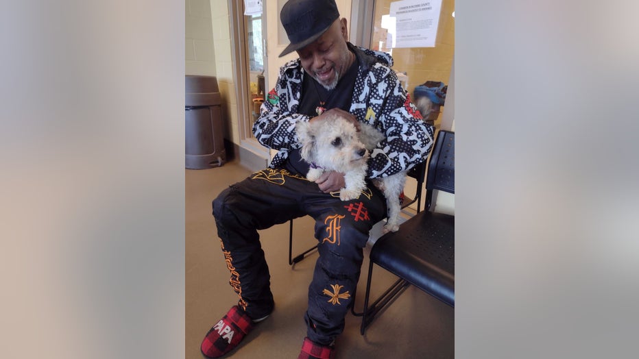 Benzo is pictured reuniting with his owner on Jan. 26, 2023. (Credit: Asheville Humane Society)