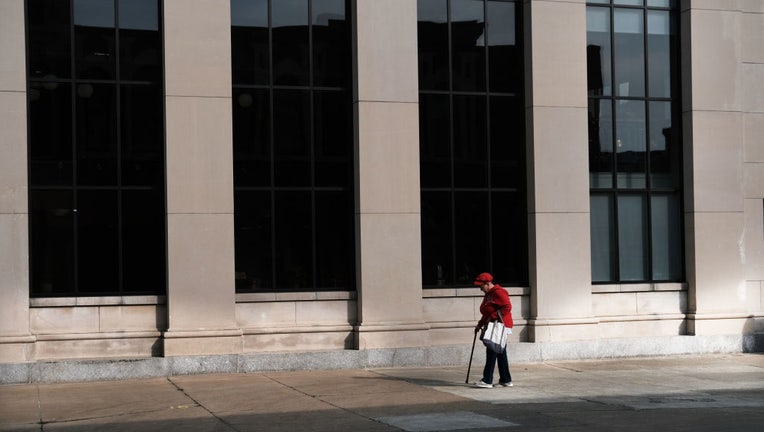 FILE - A woman walks through the city on April 11, 2019, in Binghamton, New York. (Photo by Spencer Platt/Getty Images)