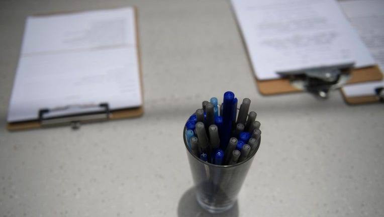 FILE - Forms and pens are pictured in a file image dated June 23, 2021 in Torrance, California.(Photo by PATRICK T. FALLON/AFP via Getty Images)