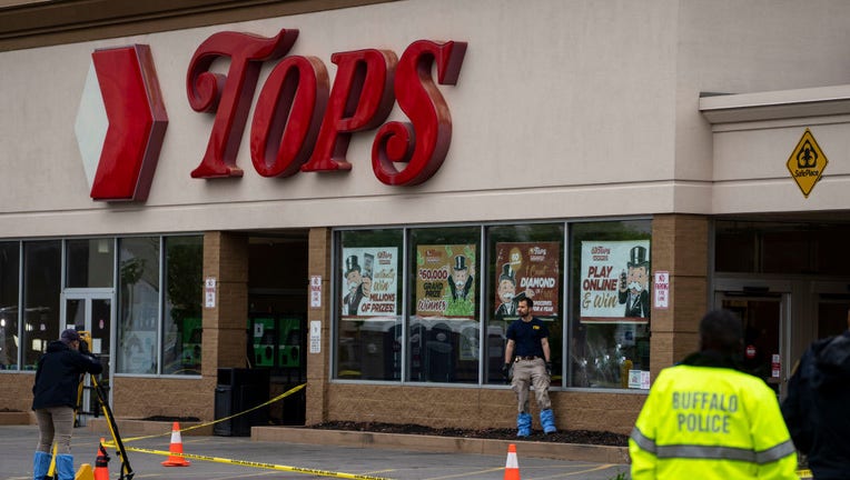 Bullet holes are seen in the window of Tops Friendly Market at Jefferson Avenue and Riley Street, as federal investigators work the scene of a mass shooting on Monday, May 16, 2022, in Buffalo, NY. (Kent Nishimura / Los Angeles Times via Getty Images)