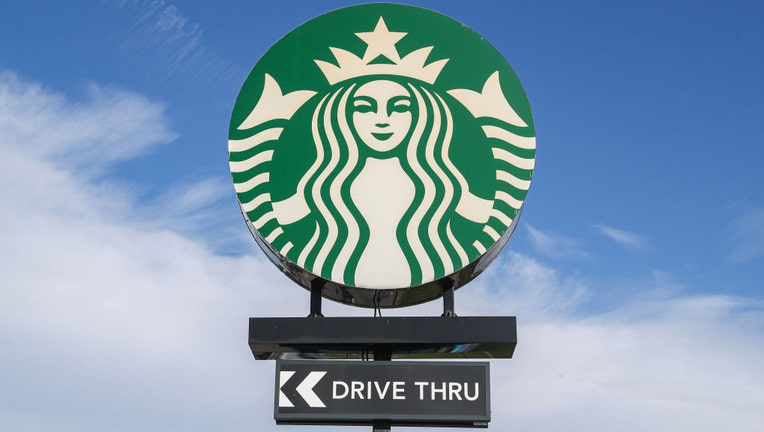 FILE - A sign with the Starbucks logo is seen at its coffeehouse. (Photo by Paul Weaver/SOPA Images/LightRocket via Getty Images)