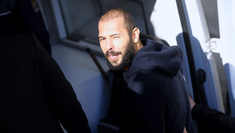 FILE - Former kickboxer Andrew Tate and his brother Tristan (not seen) leave court with police cars after their trial in Bucharest, Romania on Feb. 1, 2023. (Photo by Alex Nicodim/Anadolu Agency via Getty Images)