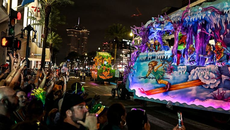 Revelers catch beads from a float in the 2023 Krewe of Proteus parade during Mardi Gras in New Orleans, Louisiana, on Feb. 20, 2023. (Photo by CHANDAN KHANNA/AFP via Getty Images)