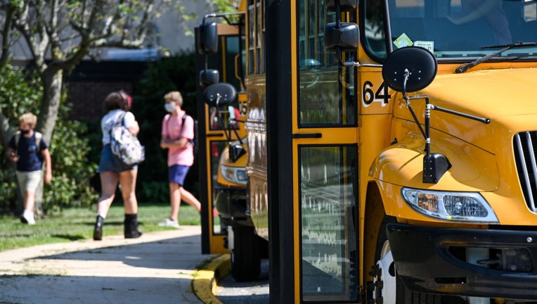 FILE - Buses wait outside a high school in Greenlawn, New York, at the end of the first day of school, on Sept. 8, 2020. (Photo by Steve Pfost/Newsday RM via Getty Images)