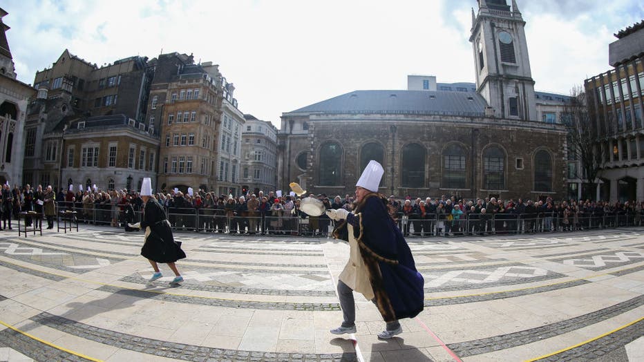 A competitor flips a pancake during the annual Inter-Livery Pancake Race on Shrove Tuesday at The Guildhall in London, United Kingdom on Feb. 25, 2020. (Photo by Dinendra Haria/Anadolu Agency via Getty Images)