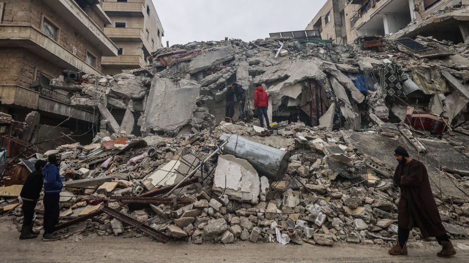 06 February 2023, Syria, Idlib: Syrian civilians inspect a destroyed residential building after the magnitude 7.8 earthquake that hit northern Syria. (Photo by Anas Alkharboutli/picture alliance via Getty Images)