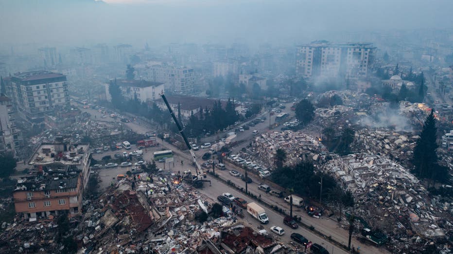 An aerial view shows smoke billowing from the scene of collapsed buildings on Feb. 8, 2023, in Hatay, Turkey. (Photo by Burak Kara/Getty Images)
