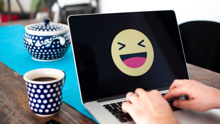 FILE - A laptop with a laughing emoji face displayed is seen in this photo illustration on Oct. 15, 2018. (Photo by Jaap Arriens/NurPhoto via Getty Images)