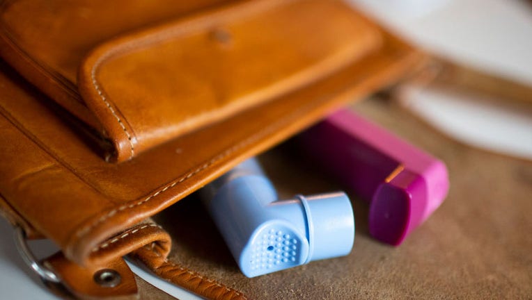 FILE - In this photo illustration lie two asthma inhalers in a handbag on Feb. 3, 2021 in Bonn, Germany. (Photo by Ute Grabowsky/Photothek via Getty Images)