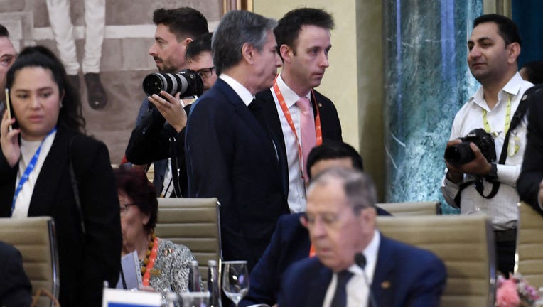 US Secretary of State Antony Blinken (top C) walks past Russian Foreign Minister Sergei Lavrov (lower) during the G20 foreign ministers' meeting in New Delhi on March 2, 2023. (Photo by OLIVIER DOULIERY/POOL/AFP via Getty Images)