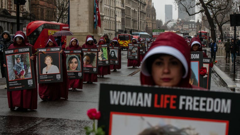 Iranian Women in handmaiden costumes march along Whitehall as a peaceful protest for women's rights on International Women's Day on March 8, 2023 in London, England. Protests continue internationally in solidarity with Iranian women in their struggle for full gender equality and to have the freedom to choose how they want to dress and live their lives without fear, assault or intimidation. (Photo by Chris J Ratcliffe/Getty Images)