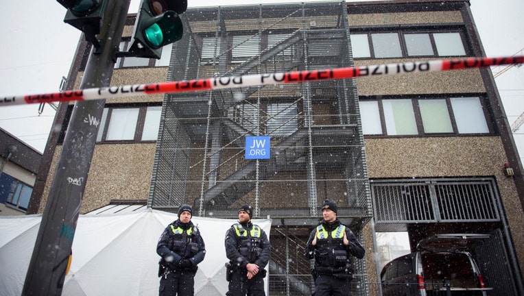 Police officers stand outside a building where a shooting the night before left at least eight people dead and eight more wounded in Alsterdorf district on March 9, 2023, in Hamburg, Germany. (Photo by Gregor Fischer/Getty Images)