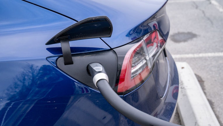 FILE - A Tesla electric car is plugged into a recharging terminal on April 27, 2022 in South Burlington, Vermont. (Photo by Robert Nickelsberg/Getty Images)