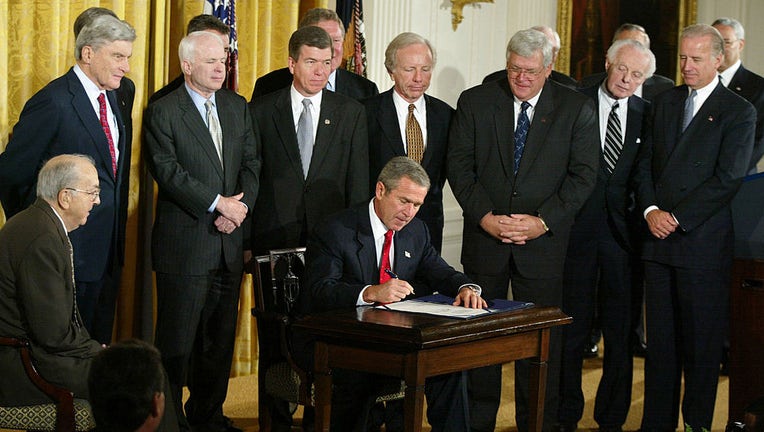 FILE - U.S. President George W. Bush signs Resolution 114, authorizing the use of force against Iraq, at the White House Oct. 16, 2002, in Washington, D.C. (Photo by Mark Wilson/Getty Images)