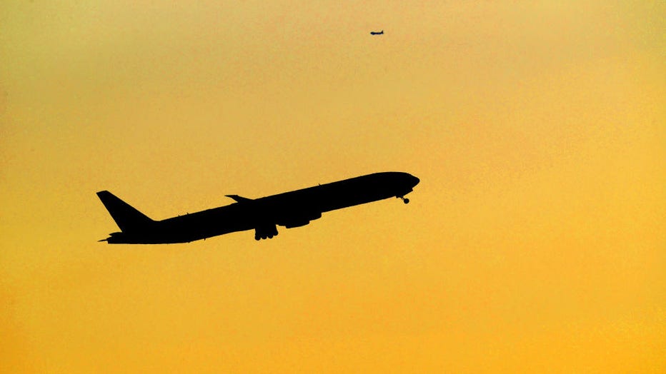 FILE - An airplane takes off from Logan Airport in the early morning sunrise on April 22, 2022. (Photo by David L. Ryan/The Boston Globe via Getty Images)