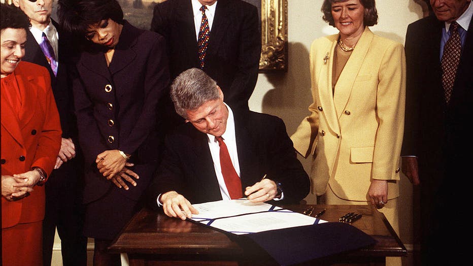 President Clinton signs the Child Protection Act as Oprah Winfrey stands next to him, along with Donna Shalala, Pat Schroeder and others, in 1993. (Photo By Cynthia Johnson/Getty Images)