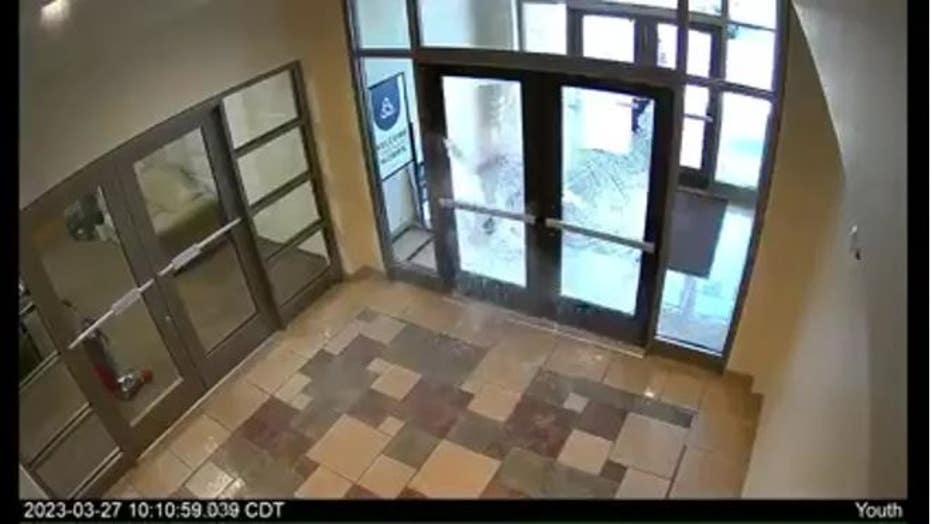 A photo taken from surveillance video showing the moment a glass double door was shot at during a shooting at The Covenant School in Nashville, Tenn.