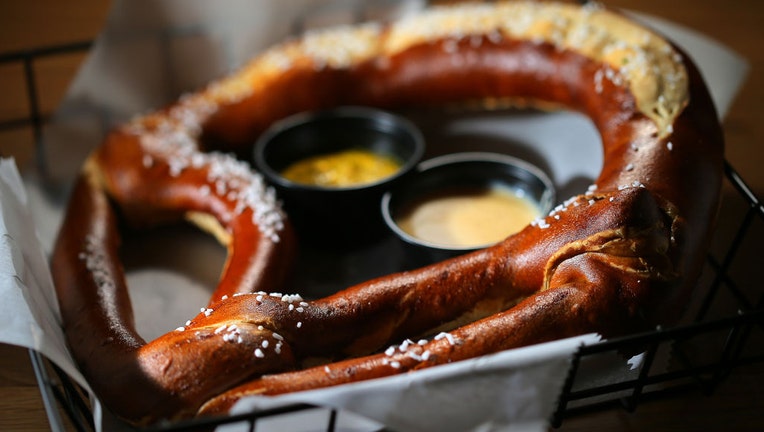 FILE - A giant soft pretzel with beer cheese and mustard is pictured in Boston on Feb. 25, 2020. (Photo by Lane Turner/The Boston Globe via Getty Images)