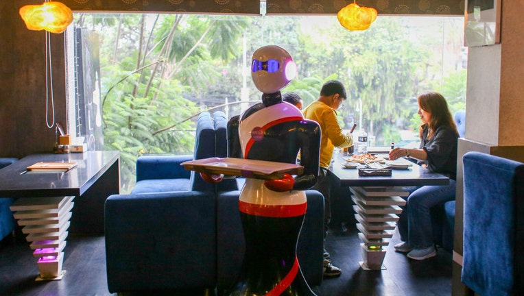 FILE - A robot serves to the customers at the Naulo restaurant in Kathmandu, Nepal on Sept. 17, 2022. (Photo by Sunil Pradhan/Anadolu Agency via Getty Images)