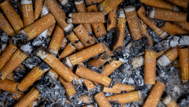 FILE - Numerous cigarette butts are pictured in an ashtray. (Photo by Sven Hoppe/picture alliance via Getty Images)