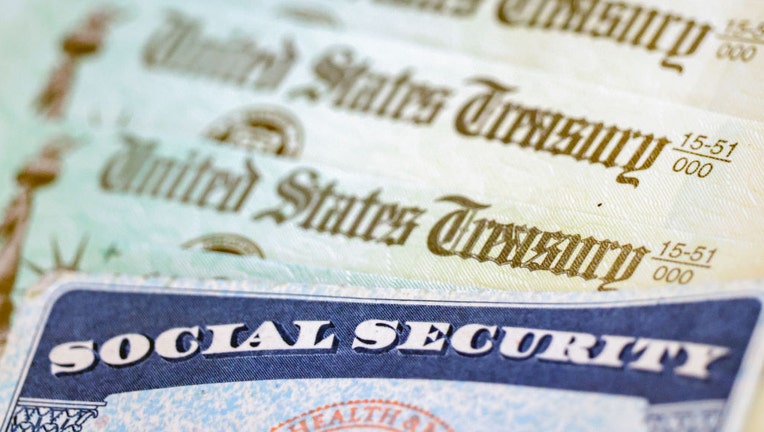 In this photo illustration, a Social Security card sits alongside checks from the U.S. Treasury on Oct. 14, 2021, in Washington, D.C. (Photo illustration by Kevin Dietsch/Getty Images)