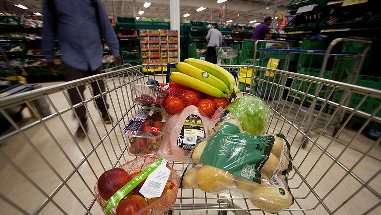 FILE - Fruit, vegetables and a whole chicken sit in a shopping cart in this arranged photograph inside a supermarket on Sept. 3, 2012. Photographer: Simon Dawson/Bloomberg via Getty Images