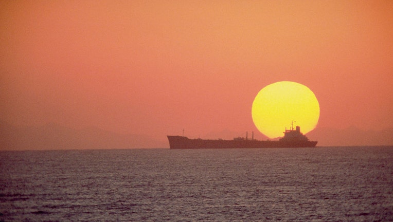 FILE - The setting sun silhouettes an oil tanker. (Photo by © CORBIS/Corbis via Getty Images)