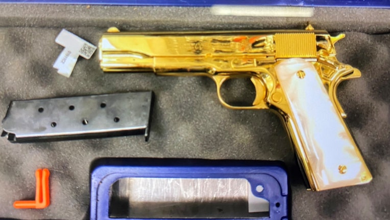 The 24-carat gold-plated handgun found in the woman’s luggage is pictured in a provided photo. (Credit: Australian Border Force)