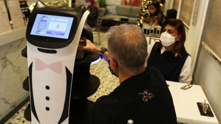 FILE - Robot waiters serve customers at Rasa Koffie, Pasar Baru, Jakarta, on Jan. 14, 2022. (Photo by Dasril Roszandi/Anadolu Agency via Getty Images)