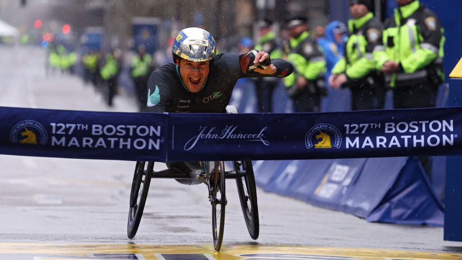 Marcel Hug of Switzerland crosses the finish line and takes first place in the professional Men's Wheelchair Division during the 127th Boston Marathon on April 17, 2023 in Boston, Massachusetts. (Photo by Maddie Meyer/Getty Images)