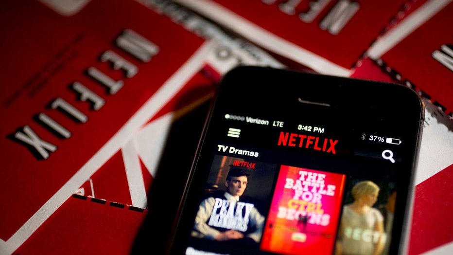 The Netflix Inc. application (app) is displayed on an Apple Inc. iPhone 5s surrounded by DVD mailers in this arranged photograph in Washington, D.C., U.S., on April 14, 2015. Photographer: Andrew Harrer/Bloomberg via Getty Images