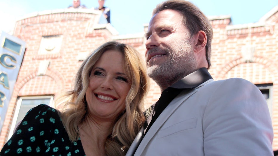 John Travolta and his wife, actress Kelly Preston, celebrate in front of the food stall "Lenny's Pizza" on 86th Street in Bensonhurst with colleagues and numerous fans on June 12, 2018. (Photo by Christina Horsten/picture alliance via Getty Images)