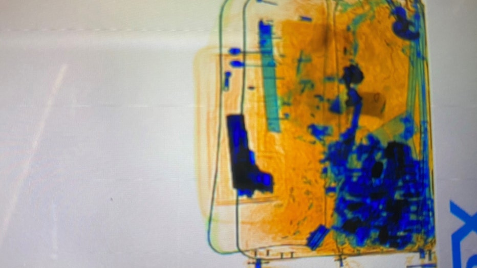 The handgun is visible in the woman’s luggage in an airport baggage scanner image. (Credit: Australian Border Force)