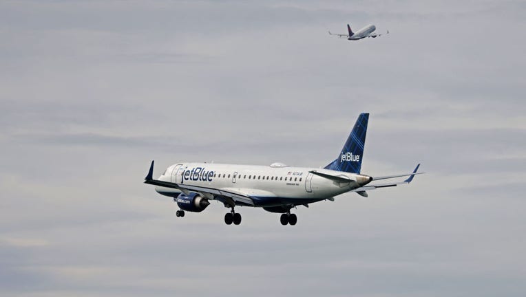FILE - A jetBlue airplane heads in for a landing at Boston Logan International Airport. (Photo by Pat Greenhouse/The Boston Globe via Getty Images)