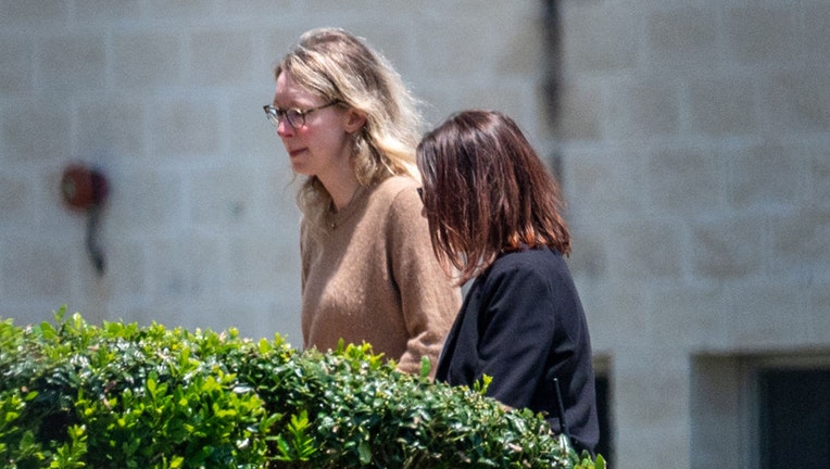 Elizabeth Holmes, founder of Theranos Inc., left, arrives at Federal Prison Camp Bryan in Bryan, Texas, US, on Tuesday, May 30, 2023. Photographer: Sergio Flores/Bloomberg via Getty Images
