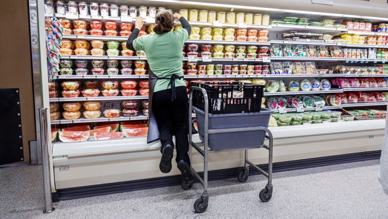 FILE - A female stocks food on a shelf at a Publix grocery store. (Photo by: Jeffrey Greenberg/Universal Images Group via Getty Images)