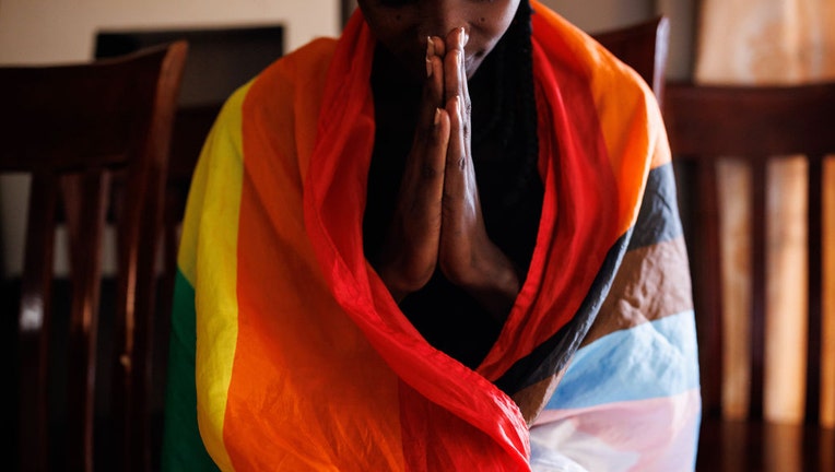 FILE - A member of the LGBTQ community prays during an evangelical church service on April 23, 2023, in Kampala, Uganda. (Photo by Luke Dray/Getty Images)