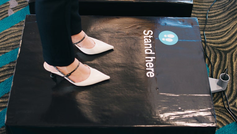 A passenger stands on a scale at Auckland Airport in New Zealand as part of a regular survey to better assess the weight and balance of a loaded aircraft. (Credit: Provided / Air New Zealand)