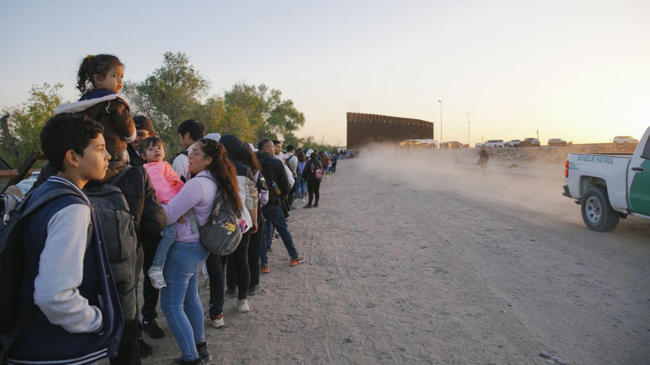 Migrants entering the USA wait in a long line at the border with Mexico, in the early morning hours of the last day of Title 42, in Yuma, Arizona, on May 11, 2023. (Photo by Katie McTiernan/Anadolu Agency via Getty Images)