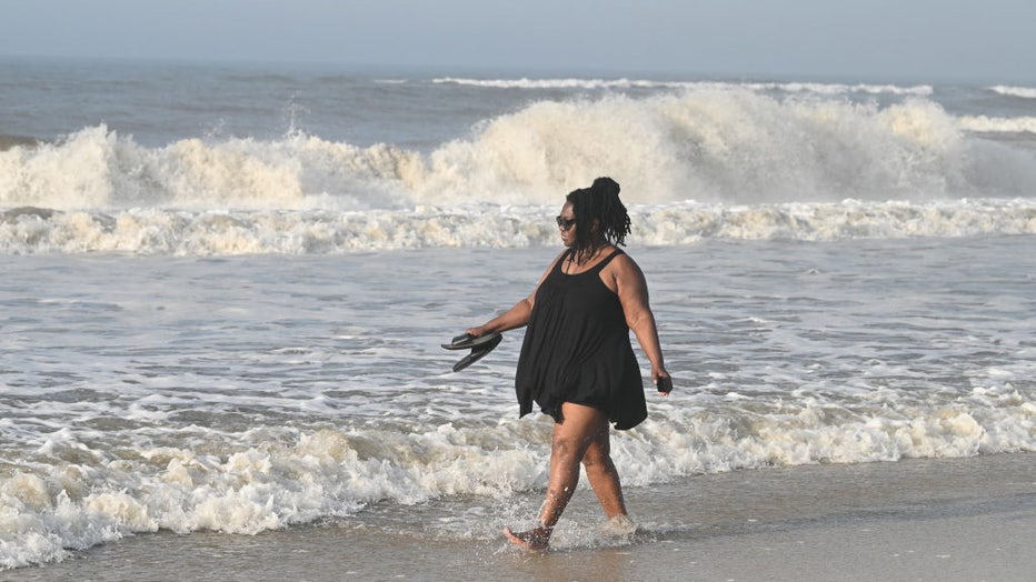 FILE - A person keeps cool by walking along the shoreline at Smith Point County Beach in Shirley, New York, on July 20, 2022. (Photo by James Carbone/Newsday RM via Getty Images)