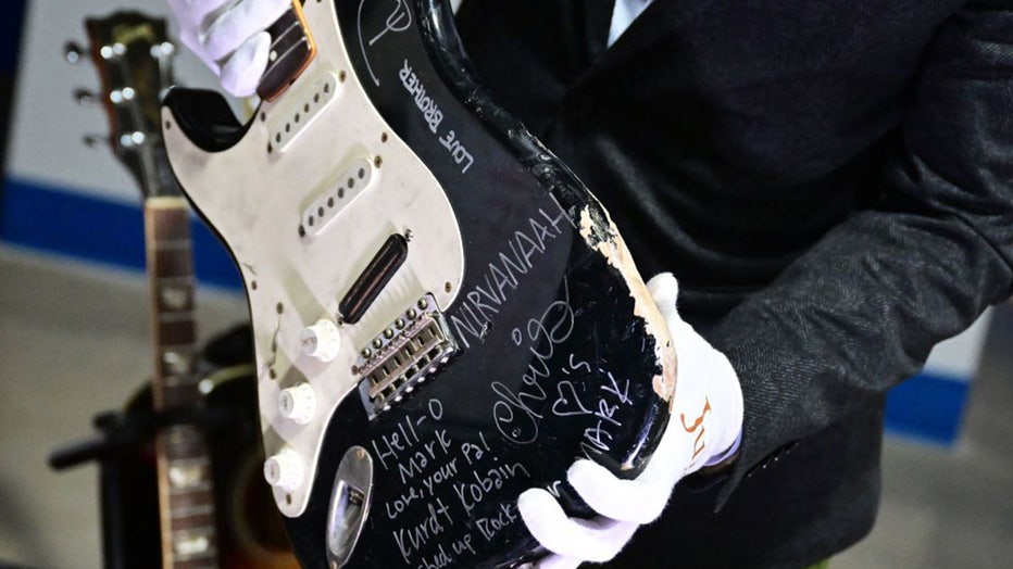 Kurt Cobain's smashed, autographed guitar sold to Nirvana fan for