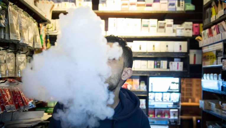 FILE IMAGE - A person exhales vapor while using an electronic cigarette device at a smoke shop in New York, on Jan. 8, 2020. Photographer: Michael Nagle/Bloomberg via Getty Images