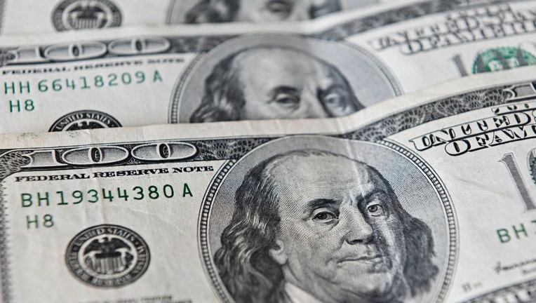 FILE - US currency is photographed on June 23, 2022.(Photo by LUIS ROBAYO/AFP via Getty Images)