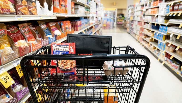 FILE - A grocery cart sits in an aisle at a grocery store on Feb. 15, 2023. (Photo by STEFANI REYNOLDS/AFP via Getty Images)