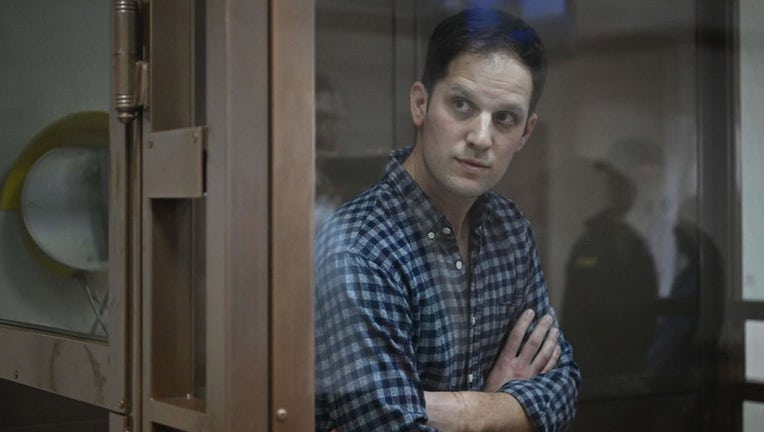 FILE - U.S. journalist Evan Gershkovich, arrested on espionage charges, stands inside a defendants cage before a hearing to consider an appeal on his arrest at the Moscow City Court in Moscow on April 18, 2023. (Photo by NATALIA KOLESNIKOVA/AFP via Getty Images)