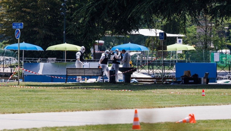 Scientific police works on the crime scene in the Paquier park where a man stabbed multiple people on June 8, 2023, in Annecy, France. (Photo by Richard Bord/Getty Images)