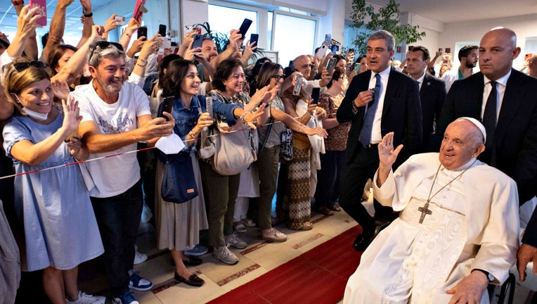 Pope Francis waves to the faithful as he leaves the Gemelli Hospital after being discharged following surgery on June 16, 2023 in Vatican City, Vatican. (Photo by Vatican Media via Vatican Pool/Getty Images)