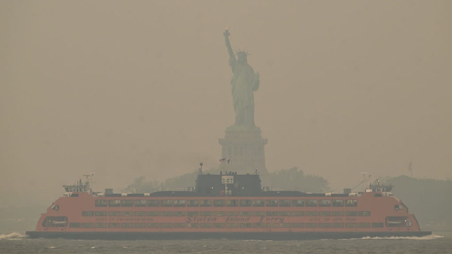 The Downtown Manhattan skyline stands shrouded in a reddish haze as a result of Canadian wildfires on June 6, 2023, in New York City. (Photo by Lokman Vural Elibol/Anadolu Agency via Getty Images)